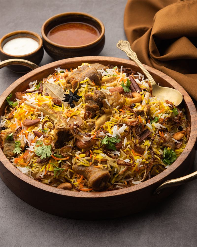 Biryani served in a carved wooden bowl